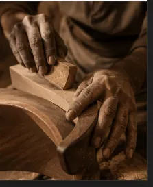 A craftsman's hands shaping a curved wooden form